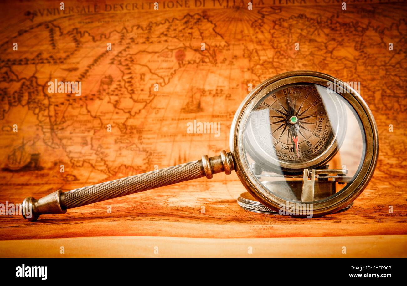 Vintage magnifying glass lies on an ancient world map Stock Photo - Alamy