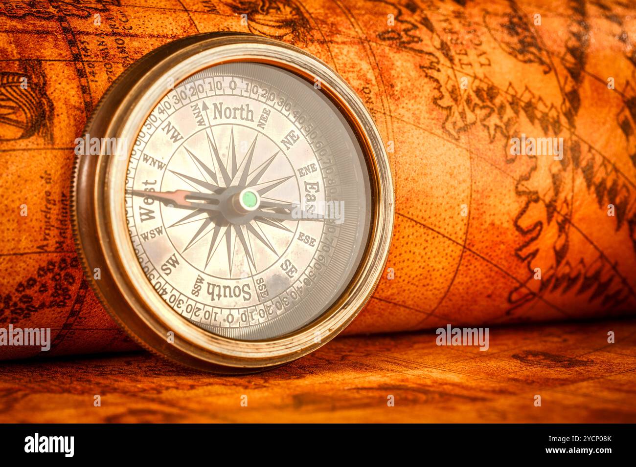 Vintage compass lies on an ancient world map Stock Photo - Alamy