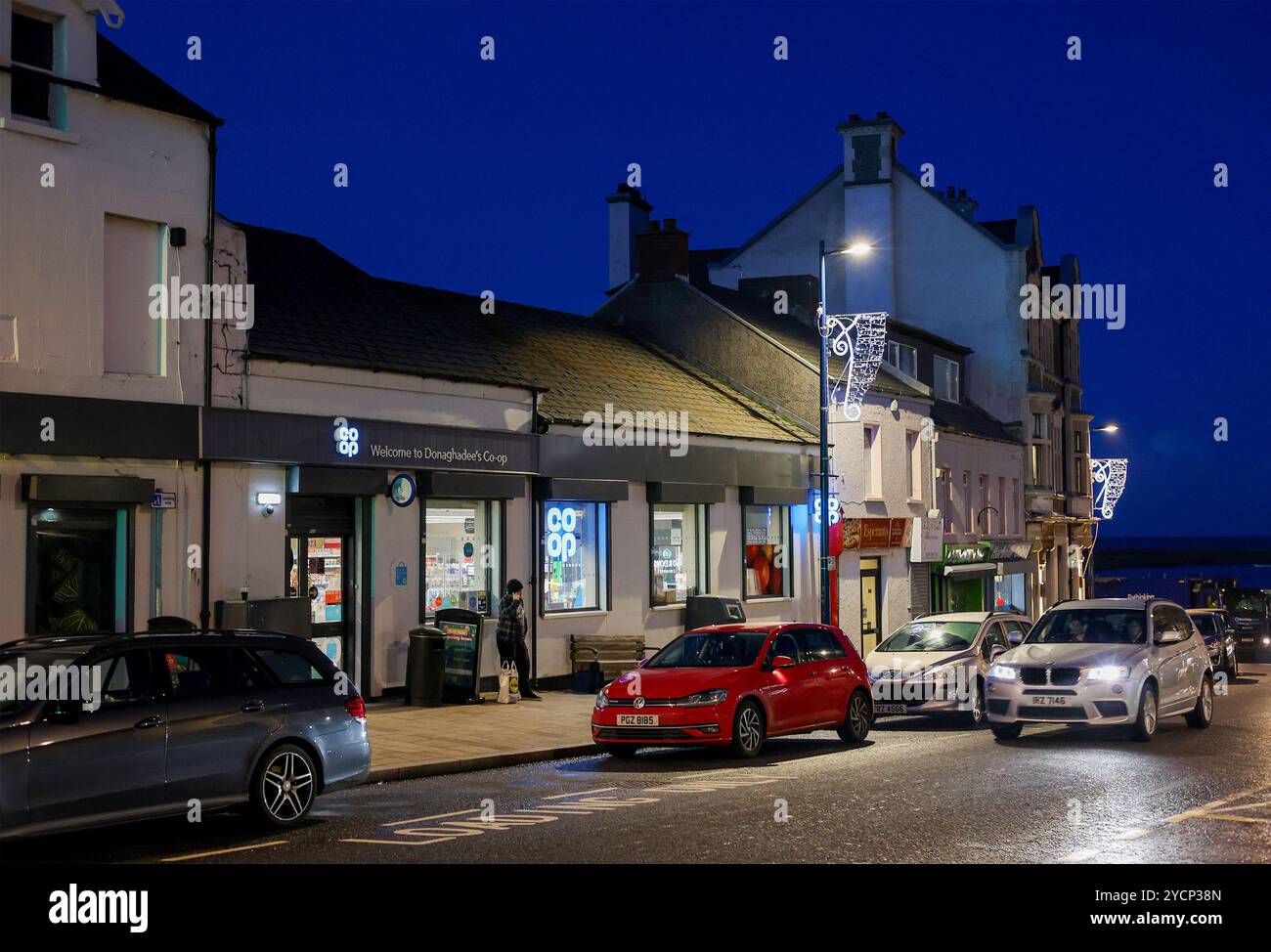Exterior night-time Co-Op store Donaghadee. Front of Co-Op store UK lit up on winter night in Northern Ireland, Donaghadee. Stock Photo