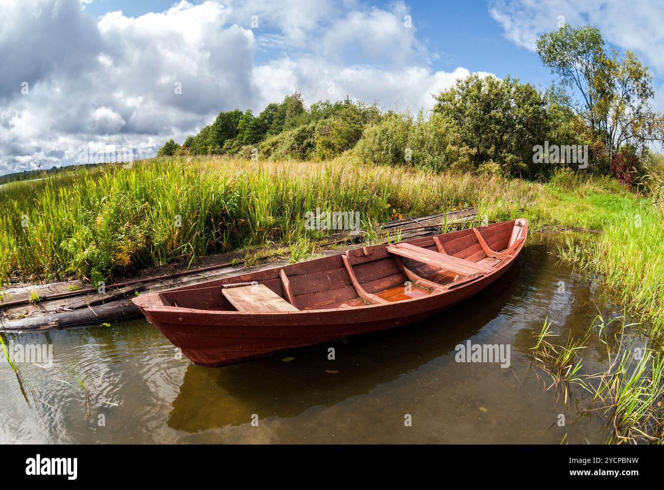 Old wooden boat at the lake in summer day Stock Photo - Alamy