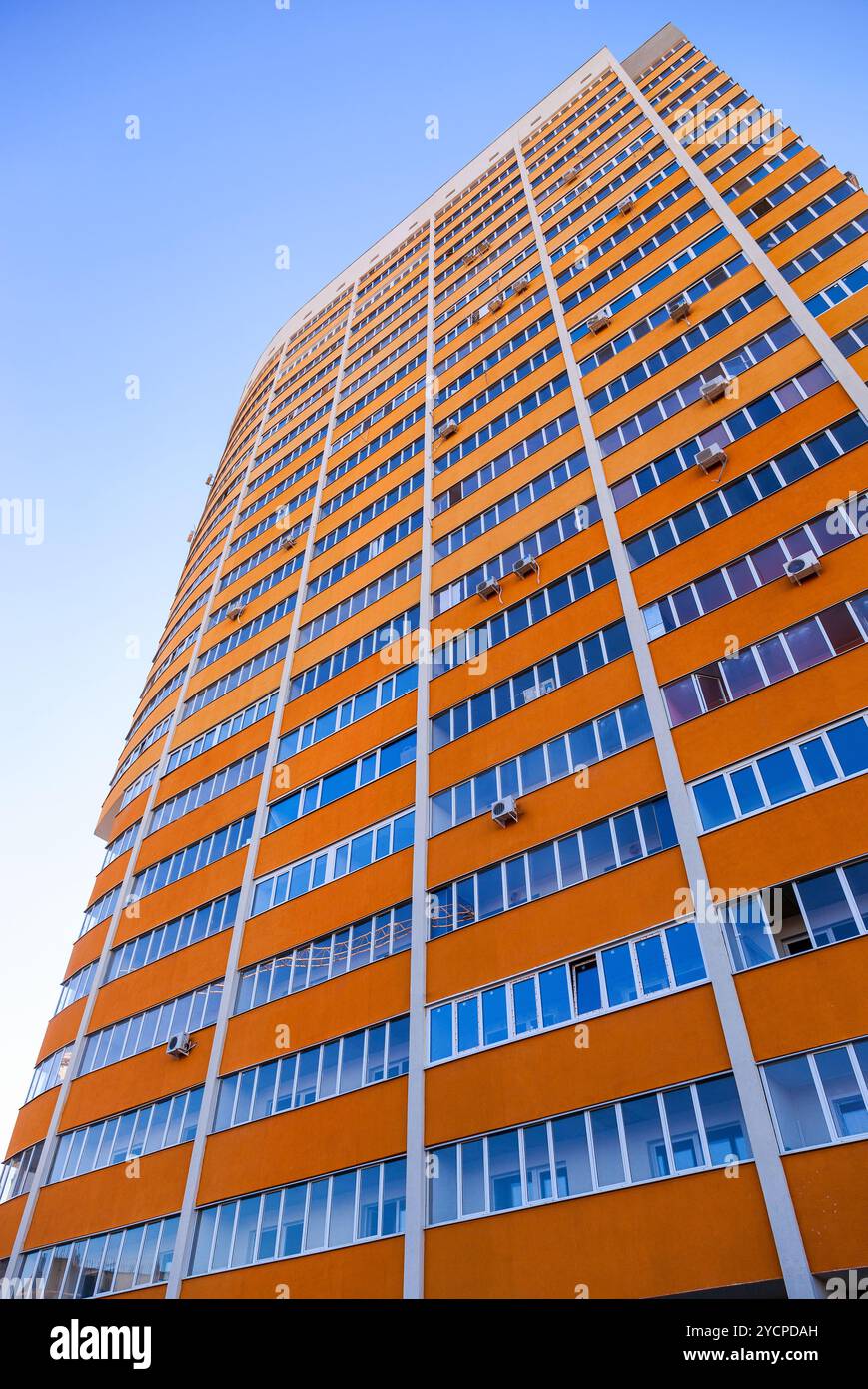 Tall apartment building on blue sky background Stock Photo - Alamy