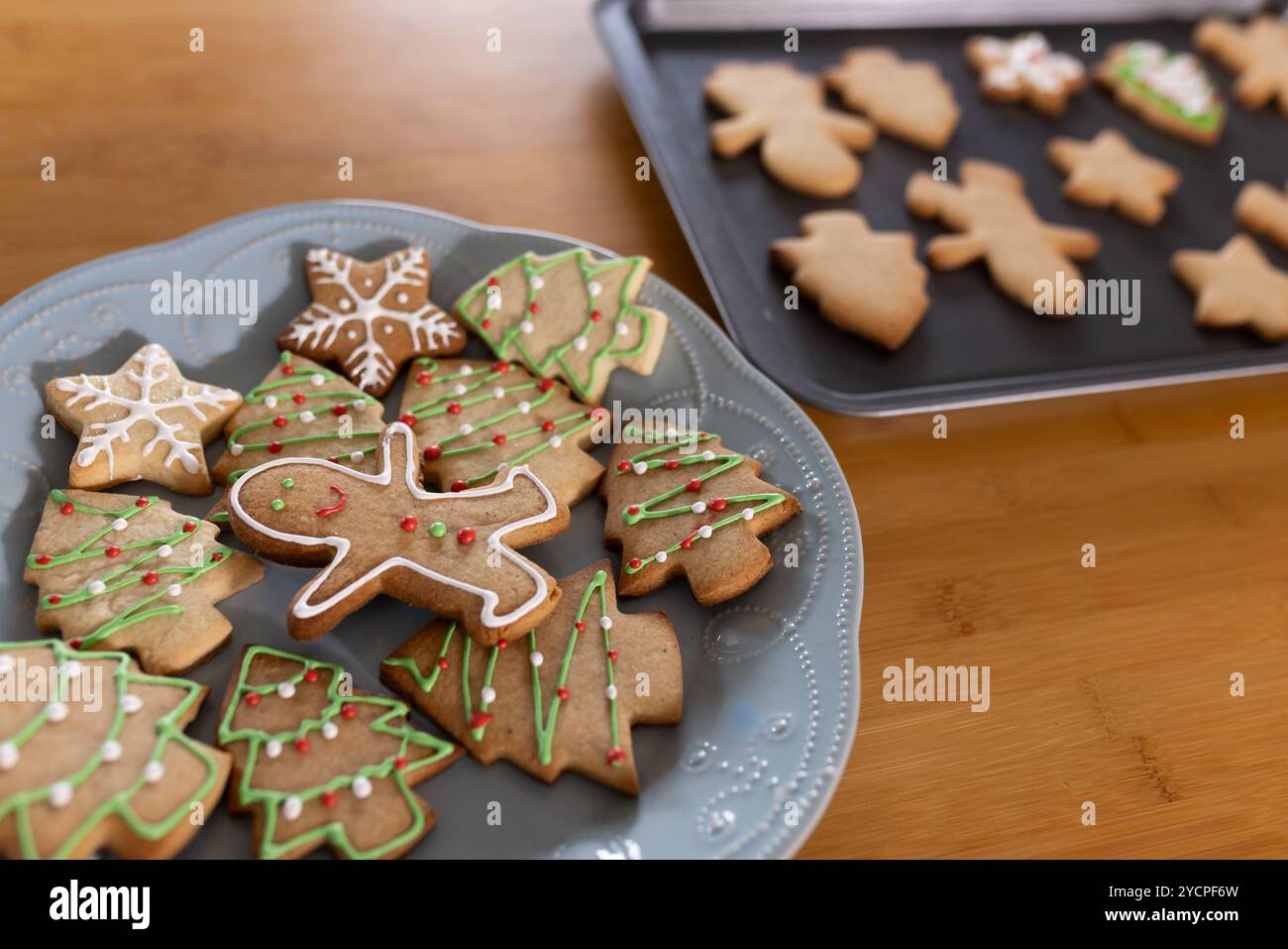 Festive gingerbread cookies decorated on plate, ready for Christmas celebration, at home Stock Photo