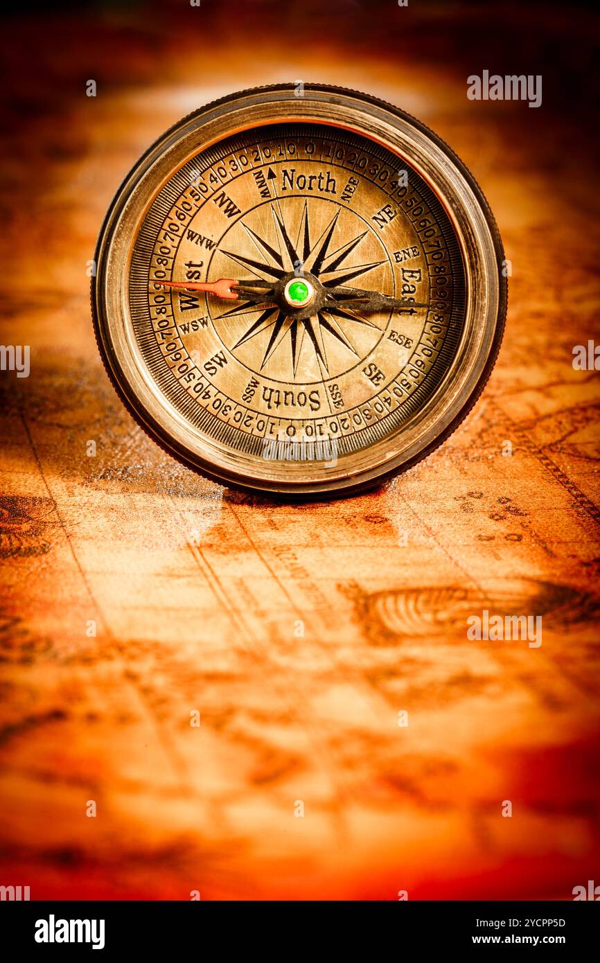 Vintage compass lies on an ancient world map Stock Photo - Alamy