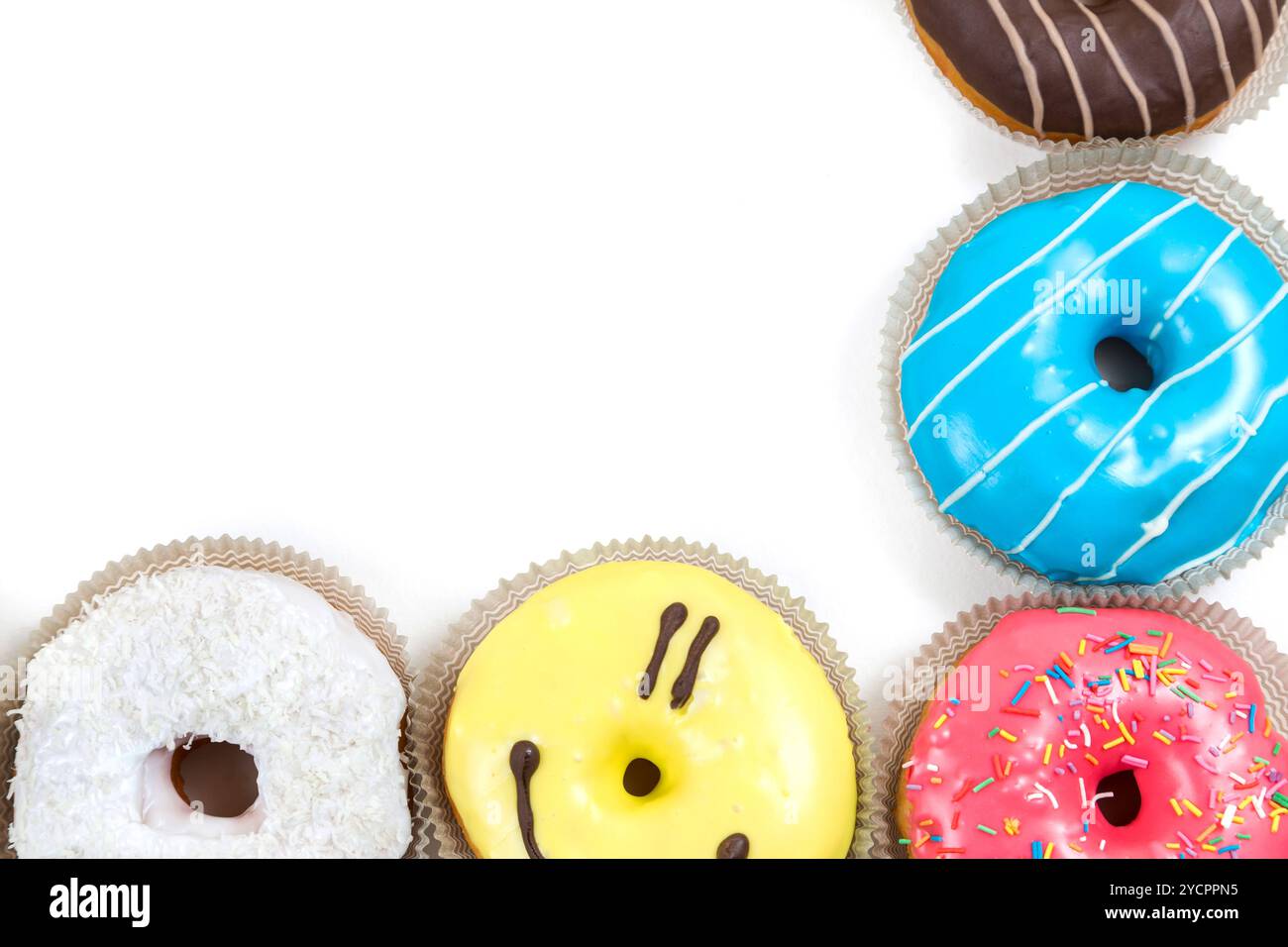 top frame from assorted glazed doughnuts in different colors on white ...