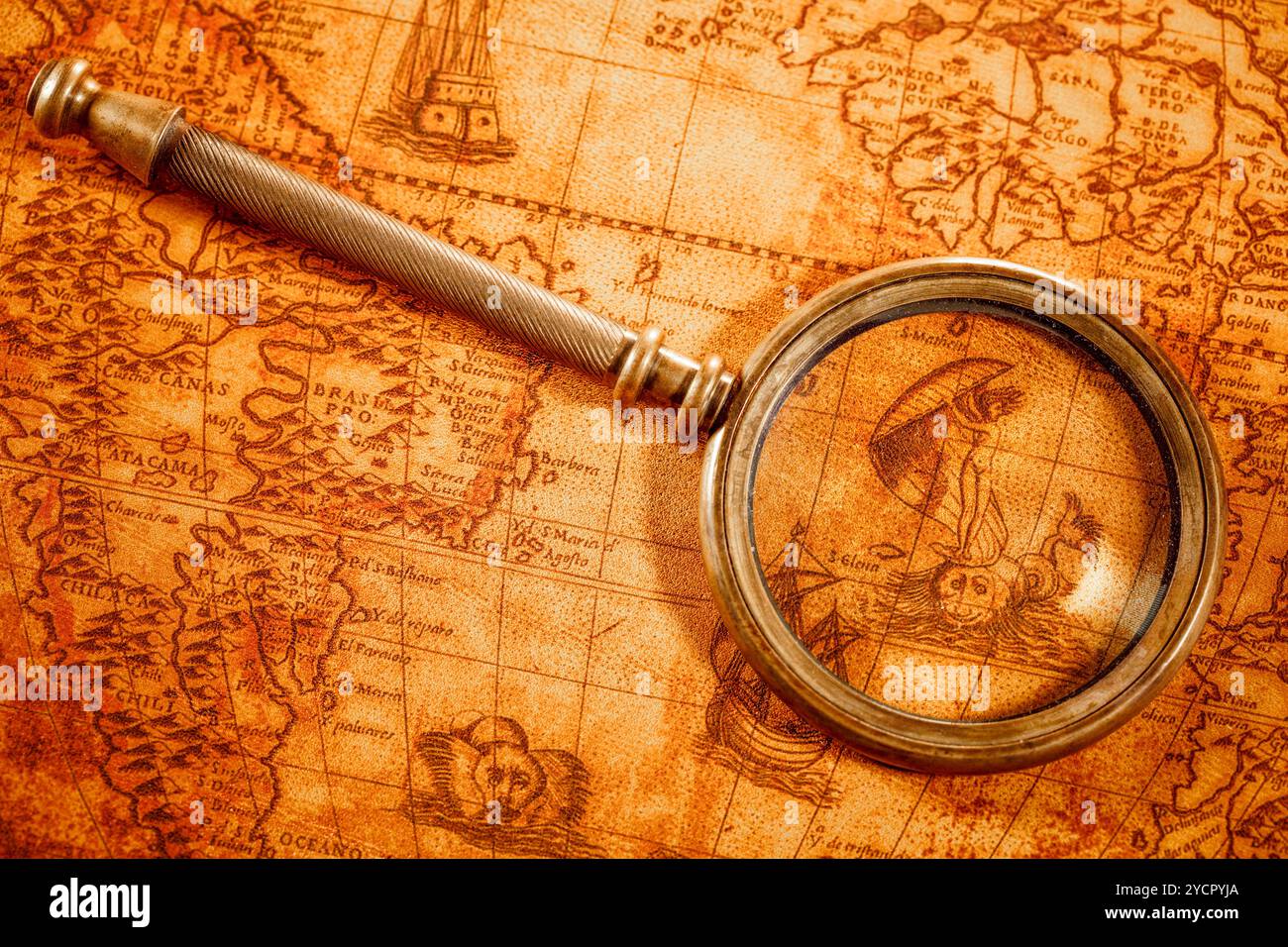 Vintage magnifying glass lies on an ancient world map Stock Photo - Alamy