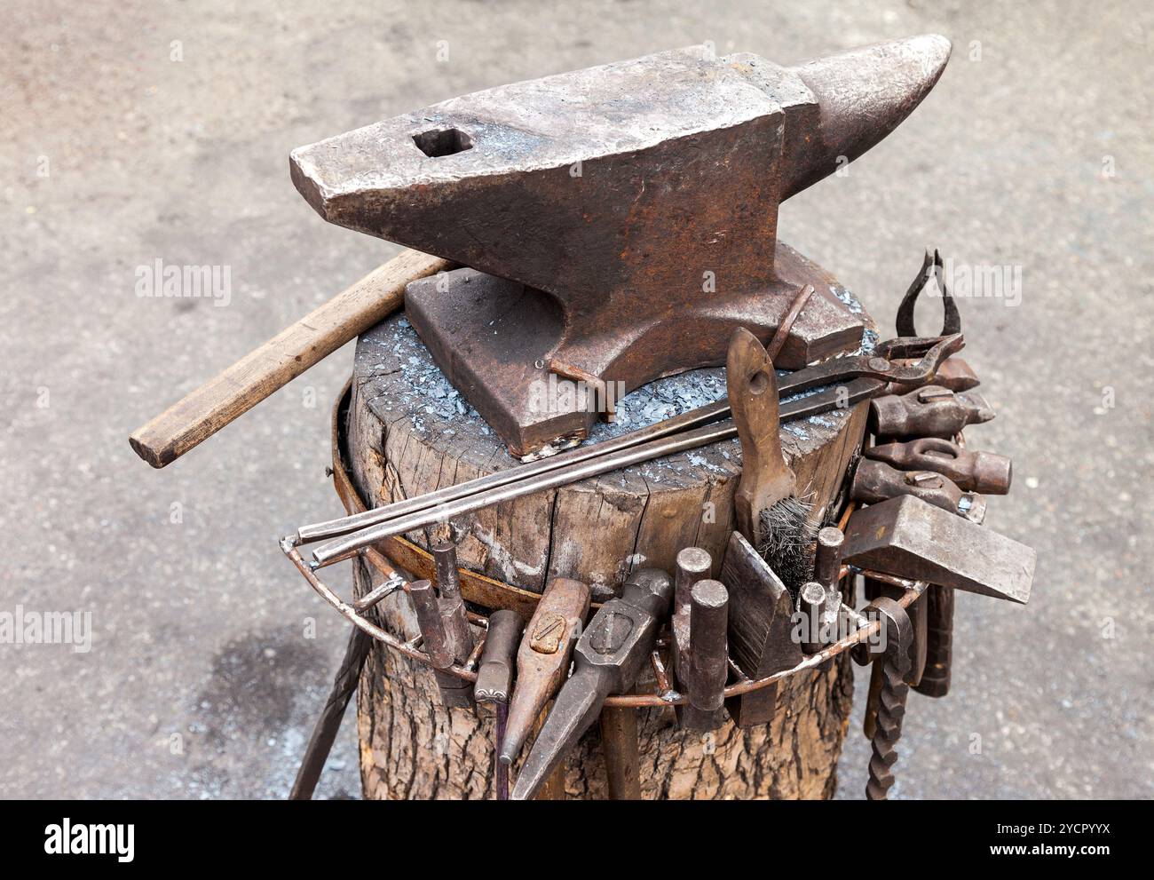 Old anvil with blacksmith tools on the outdoors Stock Photo
