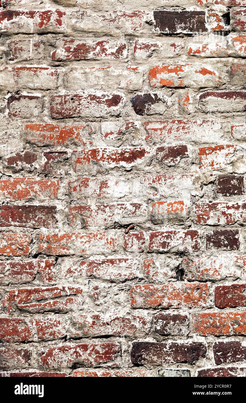 Old uneven decayed whitewashed shabby brick wall as abstract texture background Stock Photo