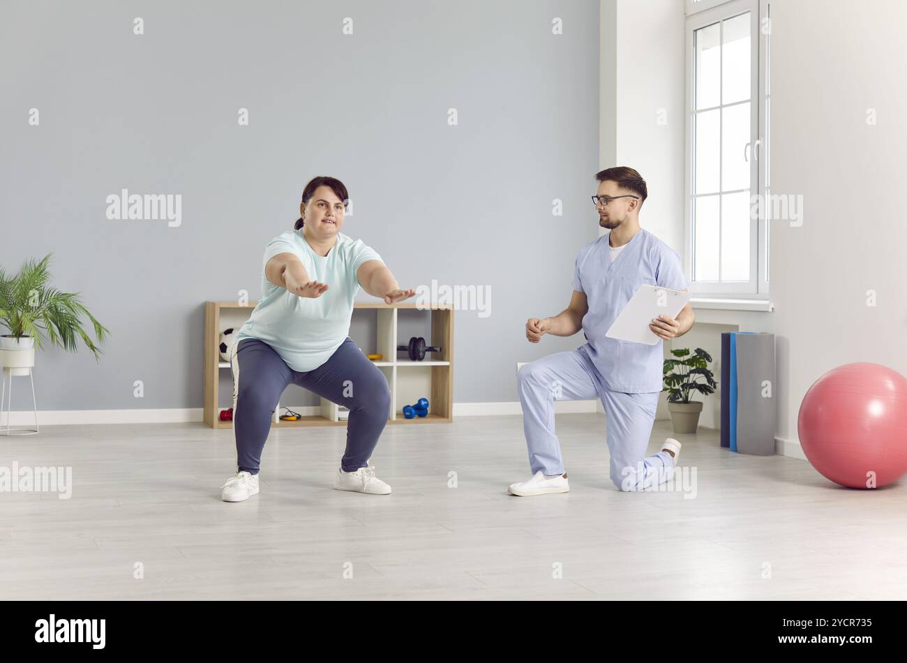 Stretch Routine For Plus Size Plus size woman doing stretching hi-res stock photography and images ...