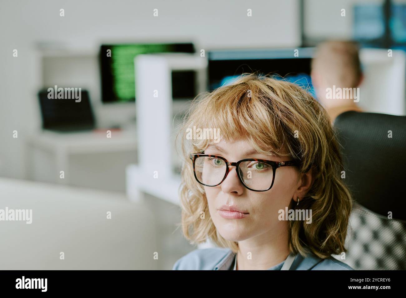 Young Woman In Eyeglasses Working On Computer Stock Photo