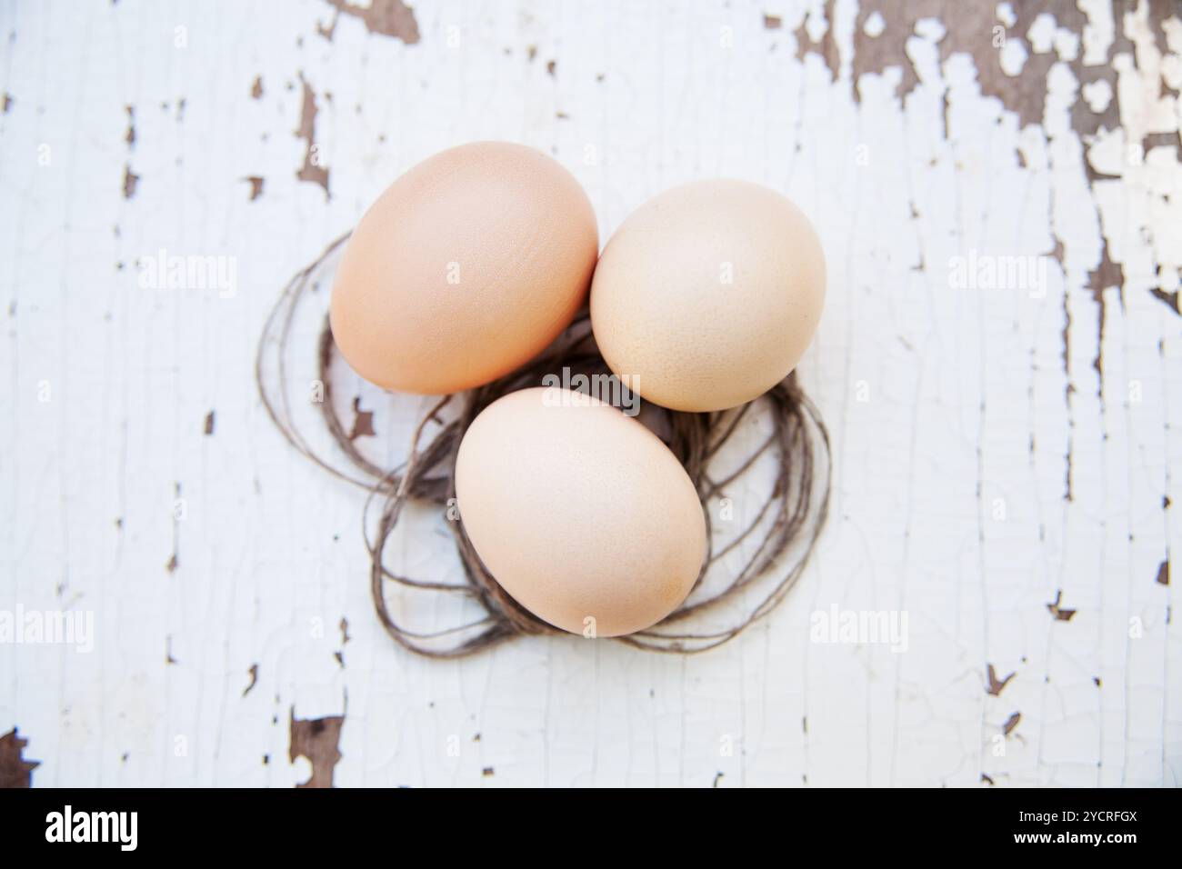 Eggs lie on an old white table Stock Photo