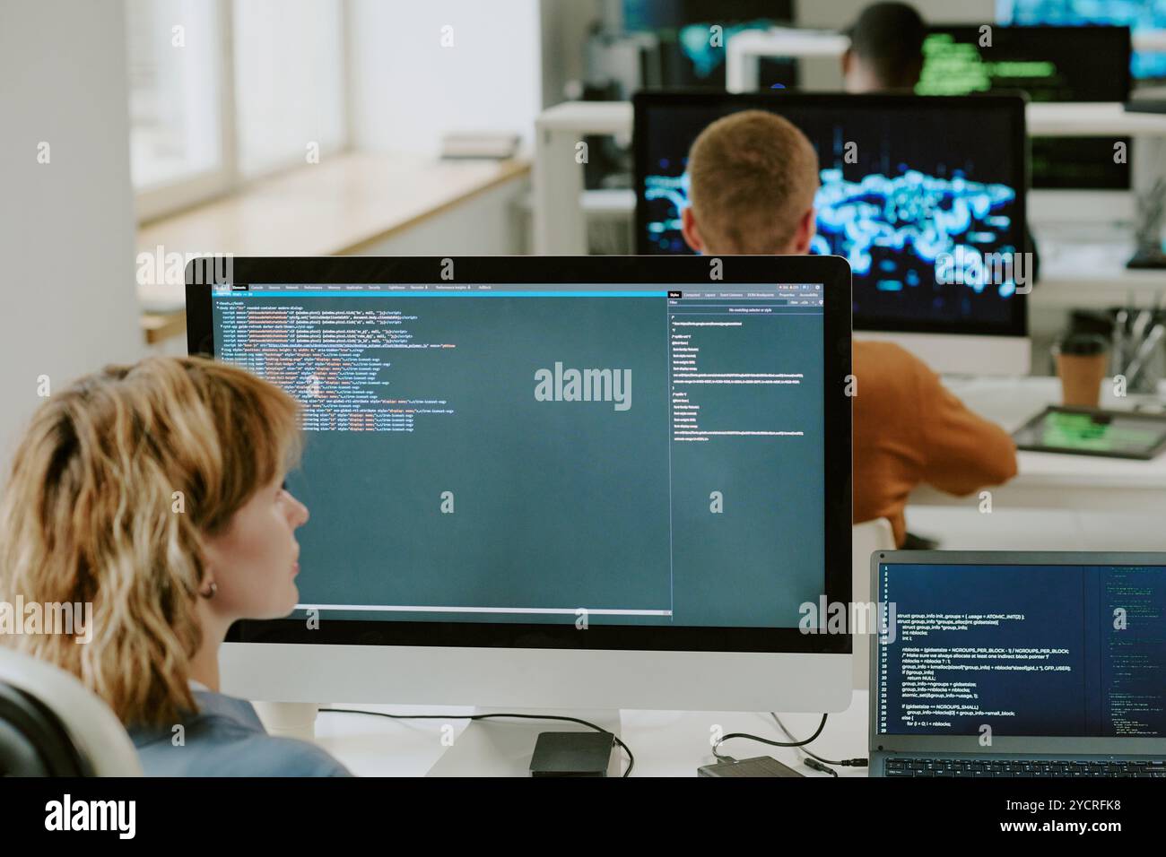 Female IT Specialist Programming On Computer In Office Stock Photo