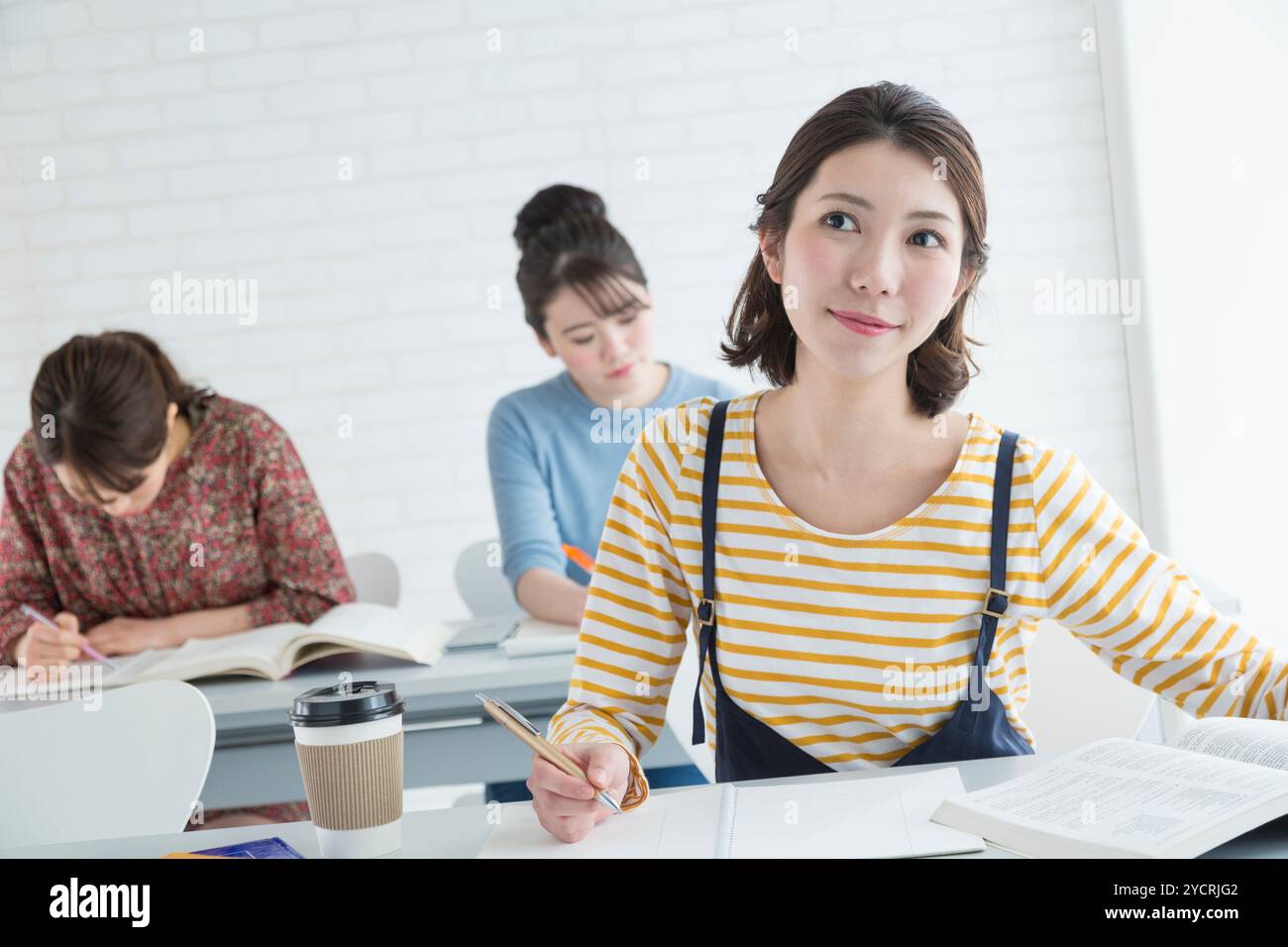 Female university students taking classes Stock Photo