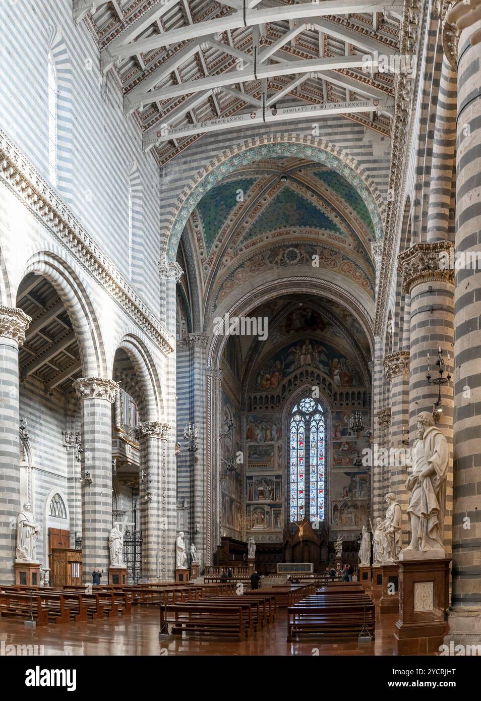 Orvieto, Italy, 18 November, 2023: interior view of the Orvieto Cathedral central nave with pews and many statues, Europe Stock Photo