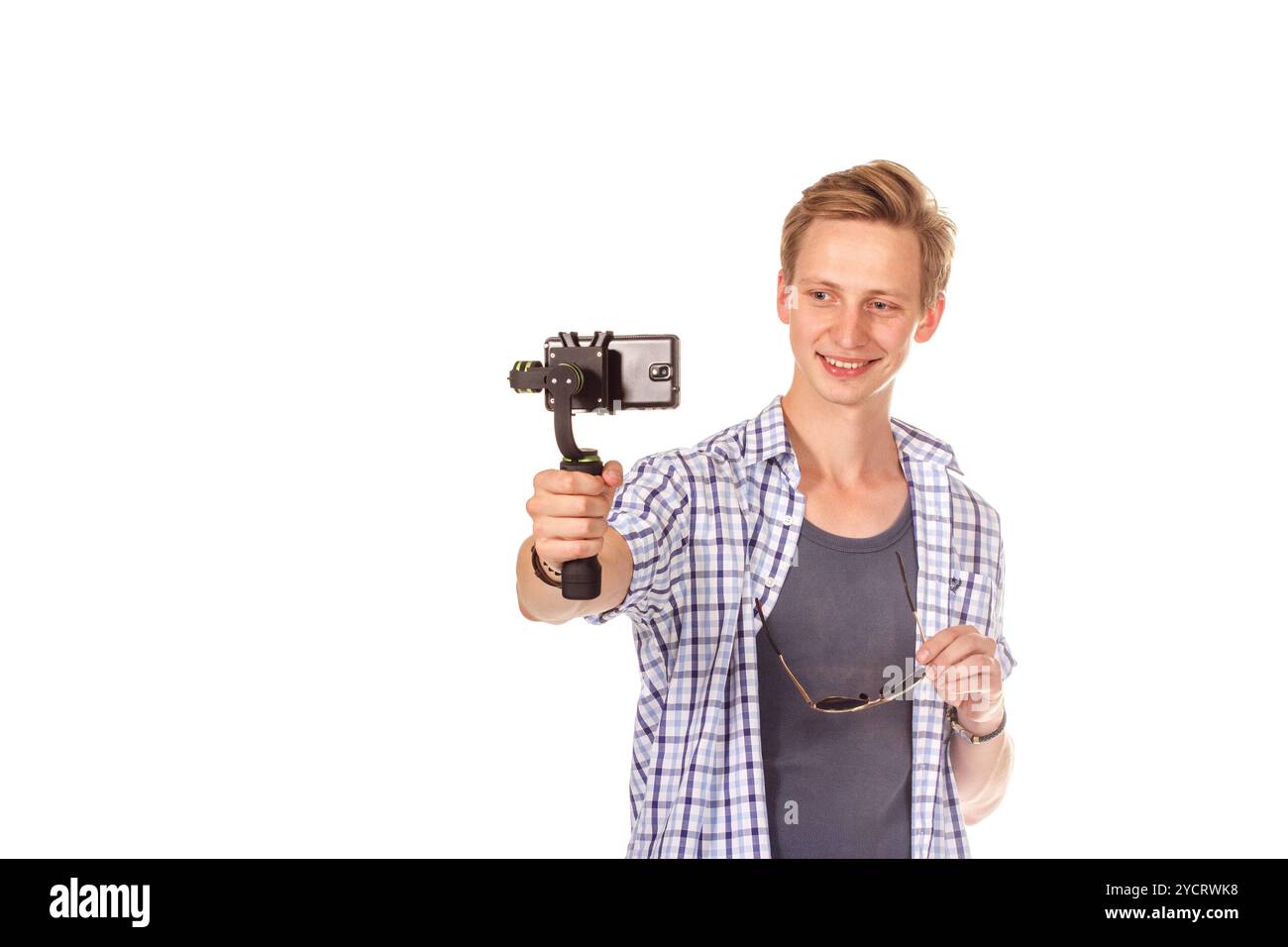 Man holds small action camera on gimbal. Stock Photo