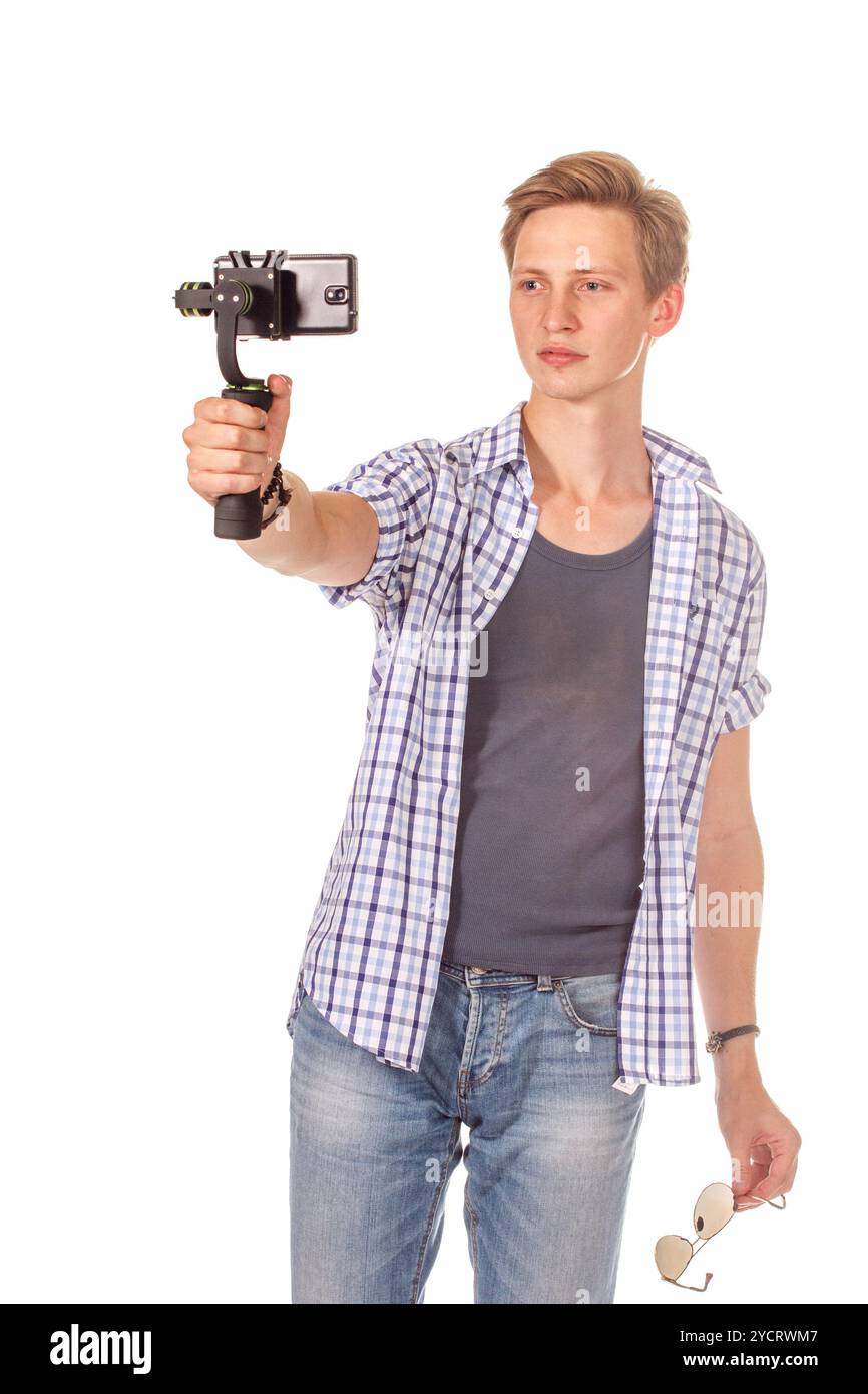 Man holds small action camera on gimbal. Stock Photo