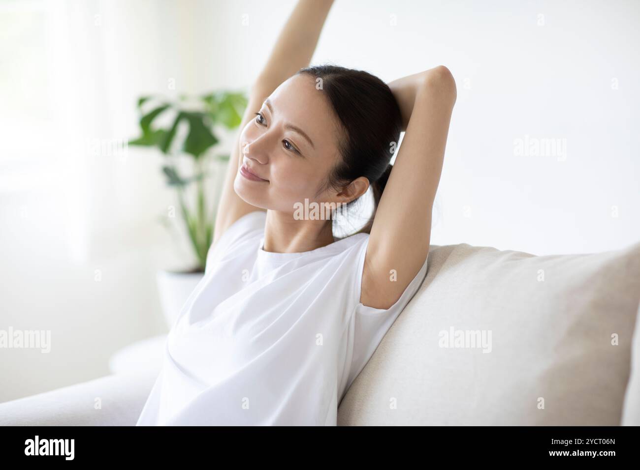 Woman relaxing on a sofa hi-res stock photography and images - Alamy