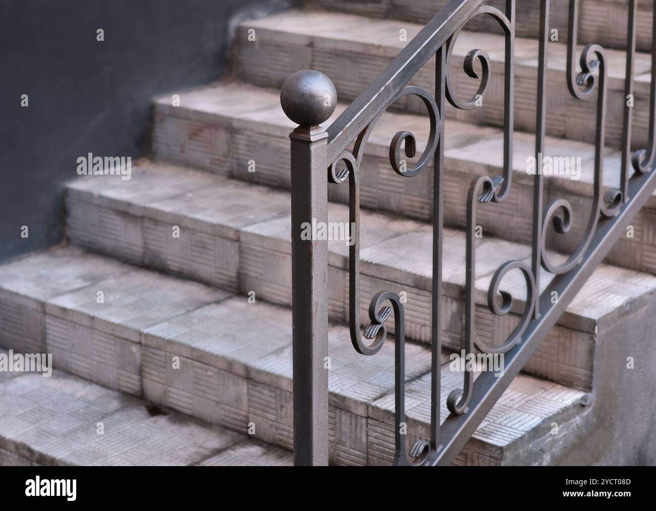 Wrought iron railing near stairs on tile porch of private home Stock ...