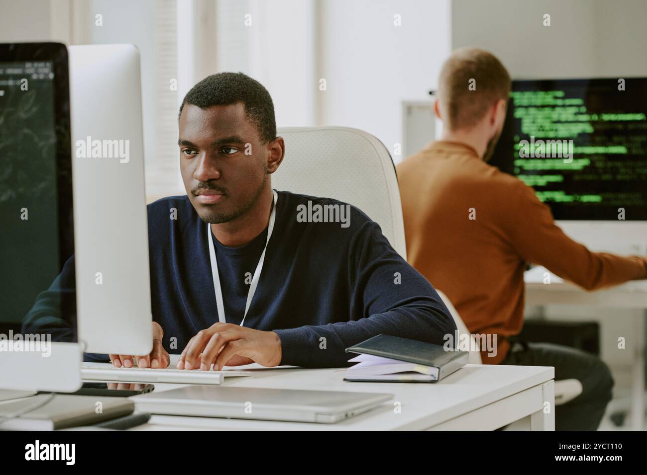 Young Black Man Typing On Computer Stock Photo