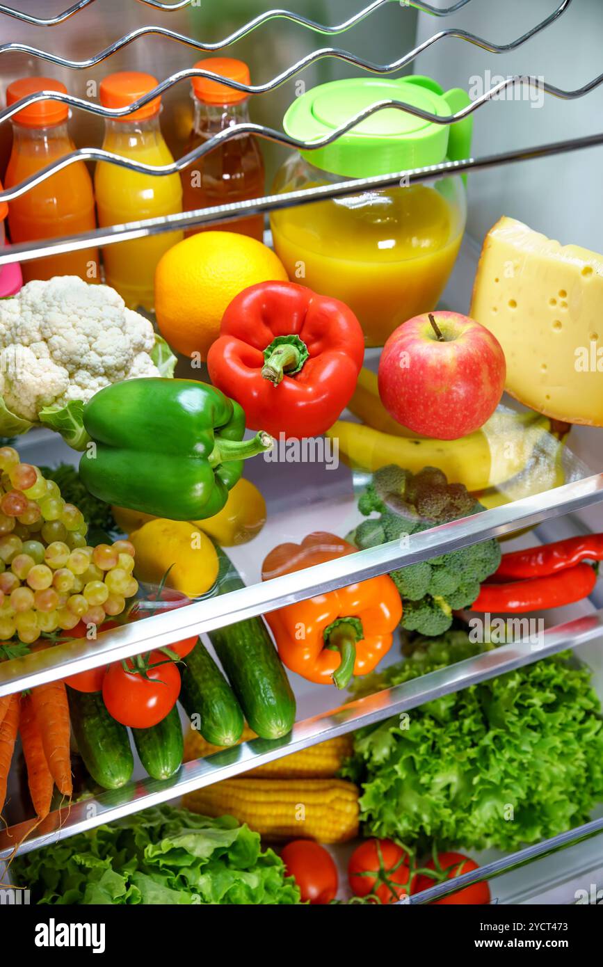 Open refrigerator filled with food Stock Photo