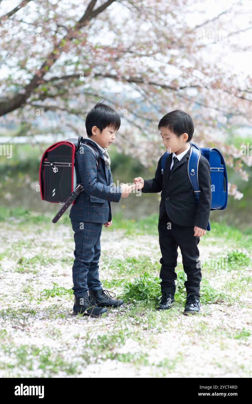 New first-year boy playing rock-paper-scissors in formal dress Stock Photo  - Alamy