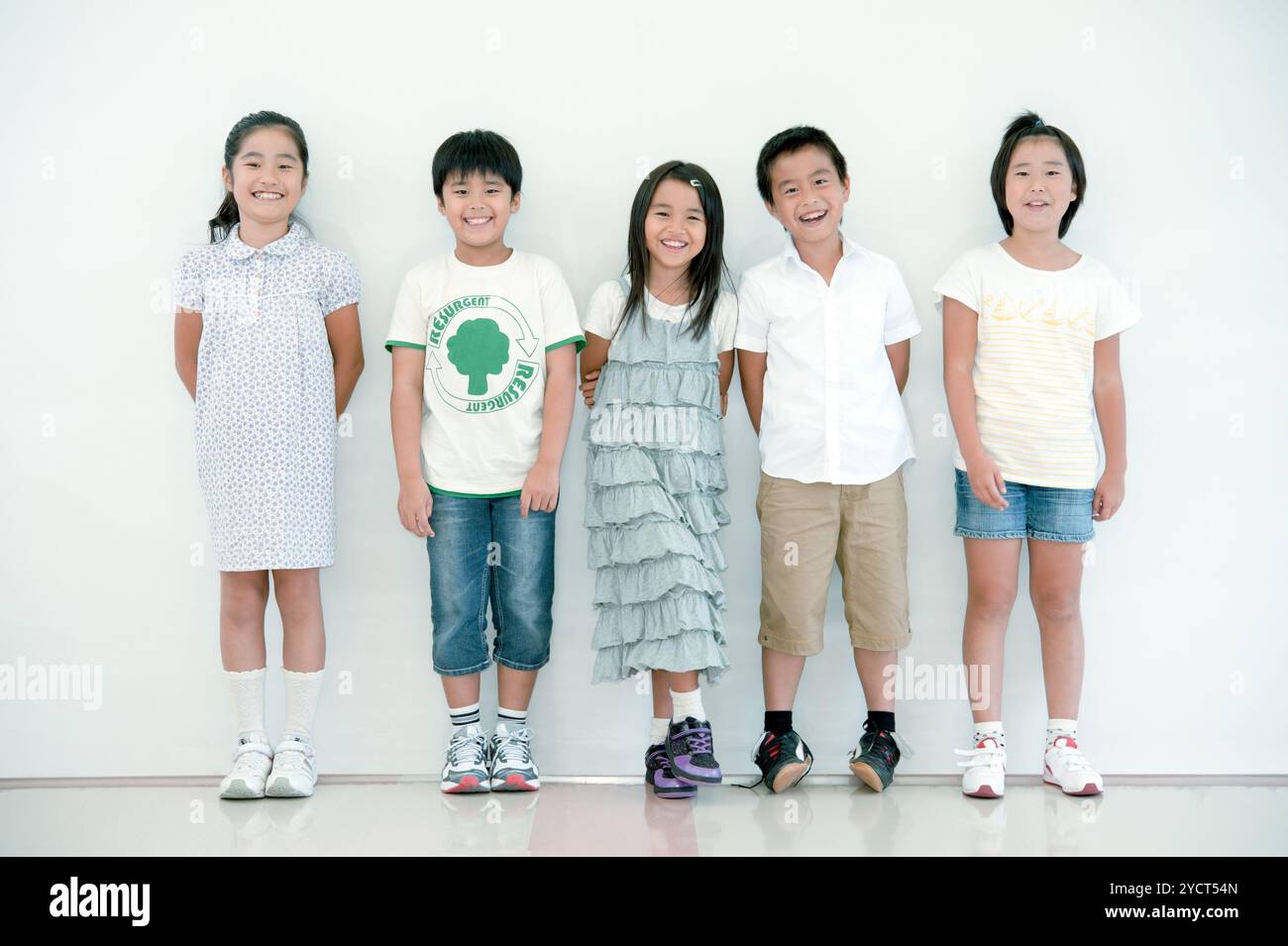 Five schoolchildren standing side by side Stock Photo - Alamy