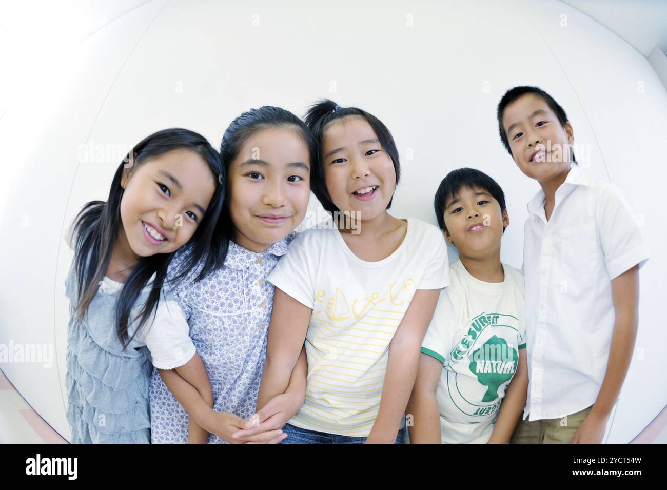 Five schoolchildren standing side by side Stock Photo - Alamy