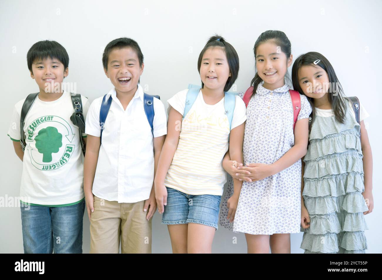 Five schoolchildren standing side by side Stock Photo - Alamy