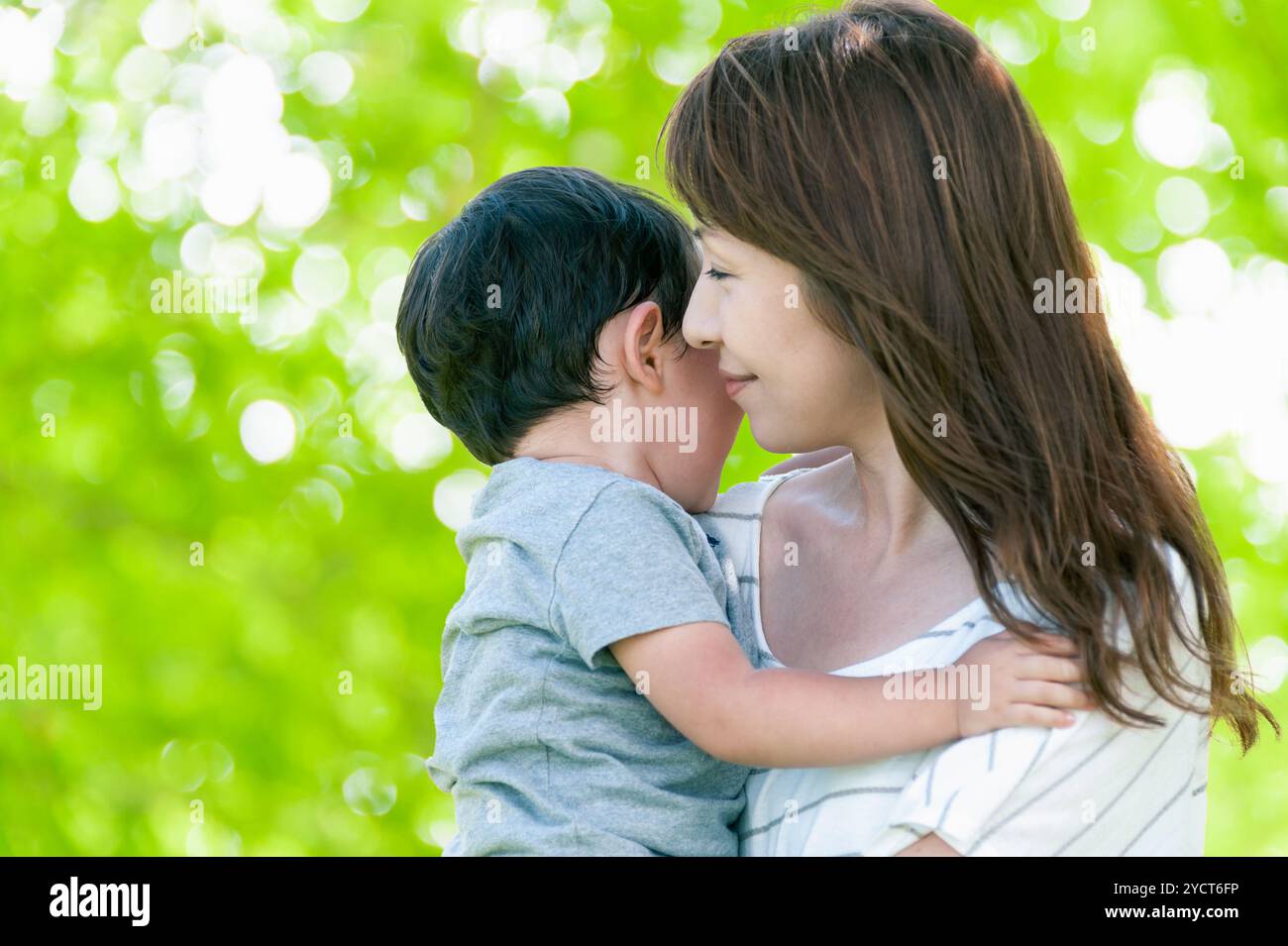 Mother happily holding boy in her arms Stock Photo - Alamy
