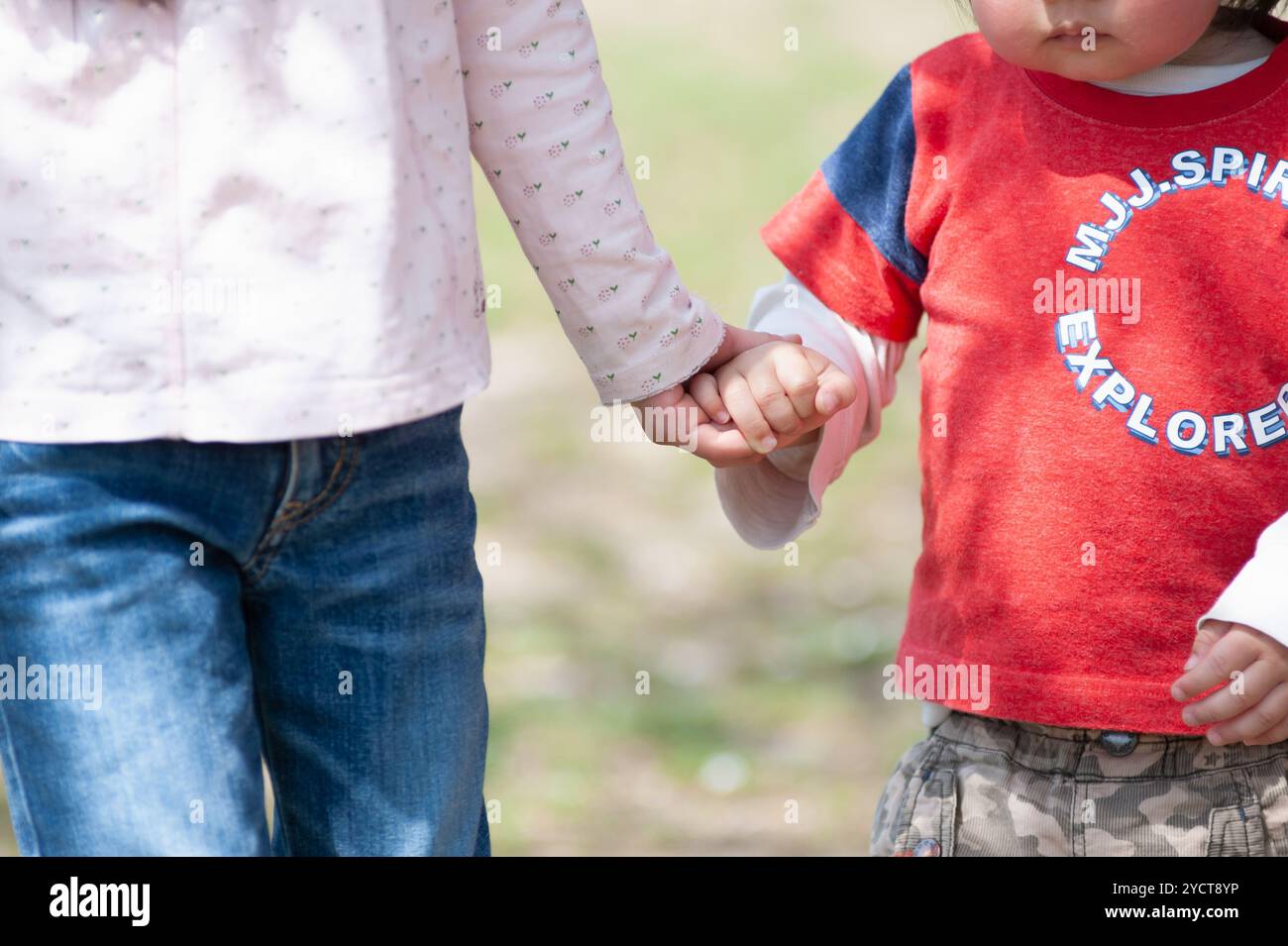 Sister and brother holding hands Stock Photo - Alamy