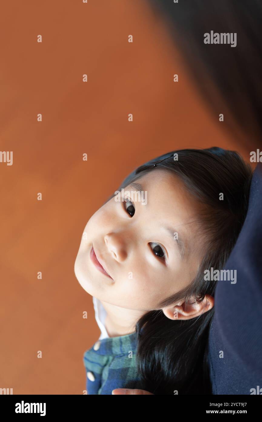 Girl looking up at her mother Stock Photo