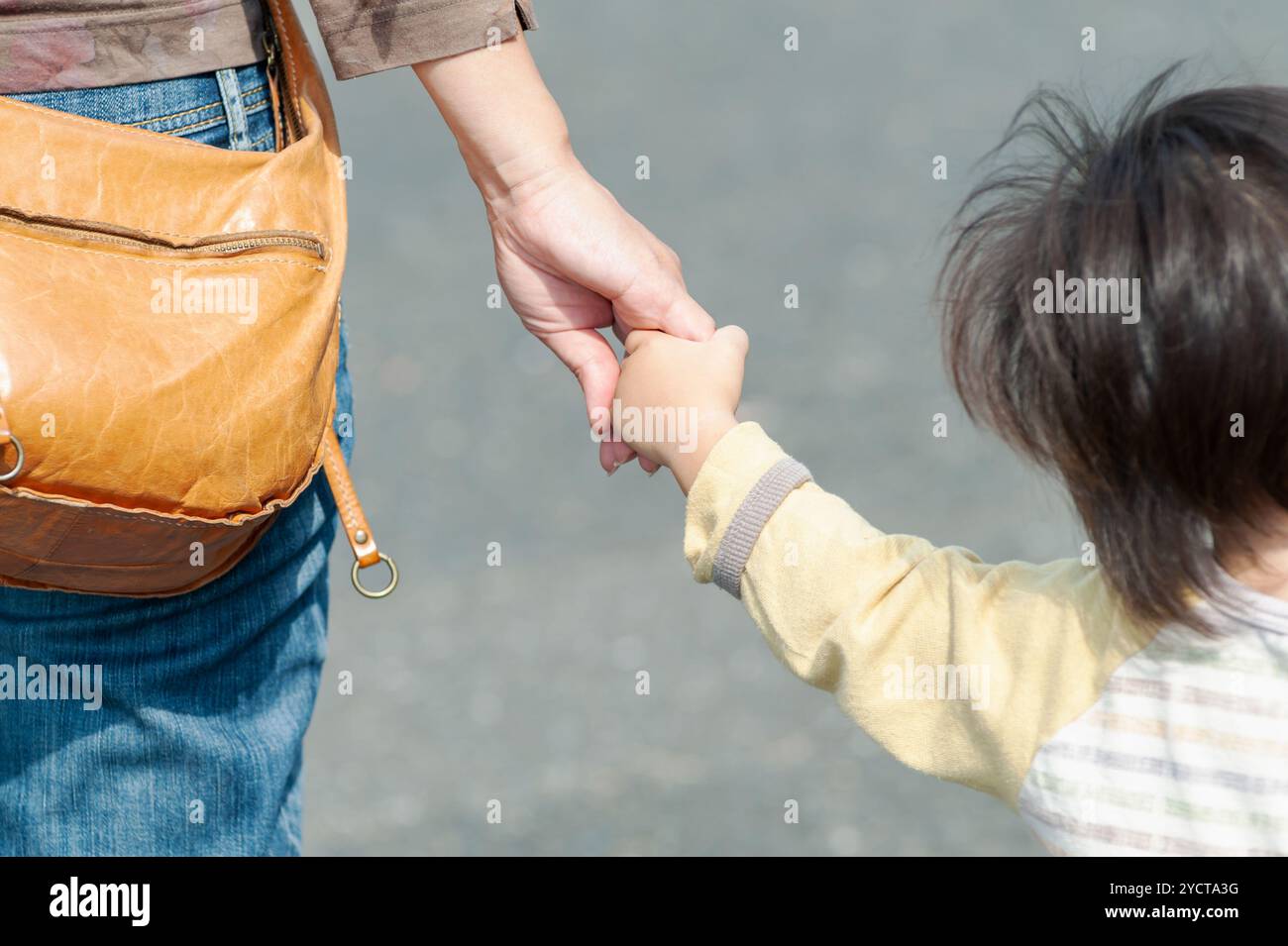 Mother and child holding hands Stock Photo - Alamy