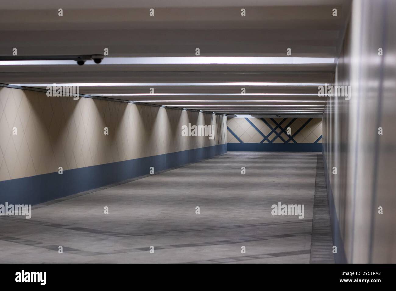 The spacious underground parking garage features a minimalist design ...