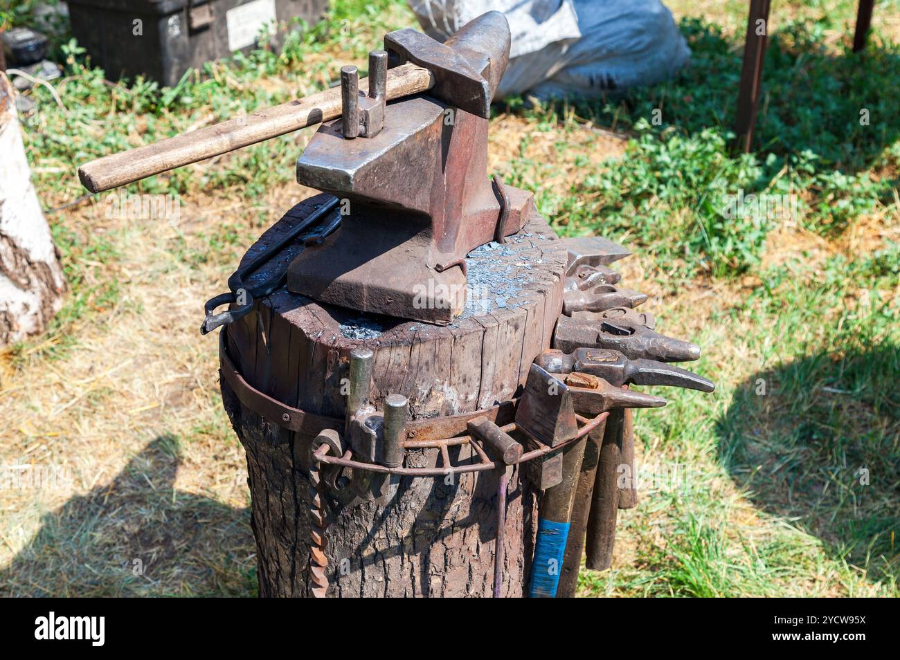 Old anvil with blacksmith tools at the outdoors Stock Photo