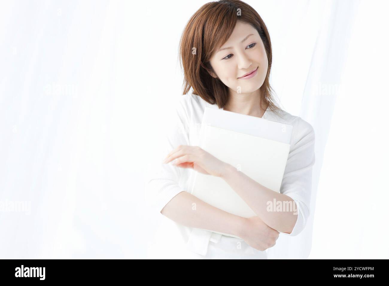 Woman holding a book Stock Photo