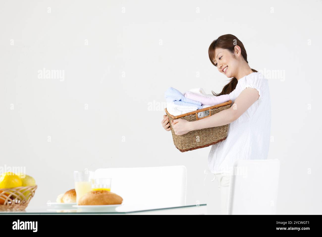 Woman with laundry basket Stock Photo