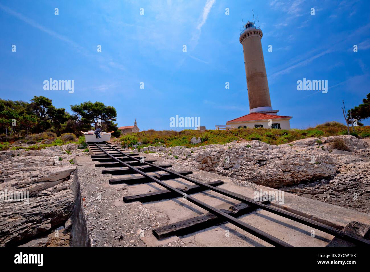 Veli Rat lighthouse and boat extraction tracks Stock Photo