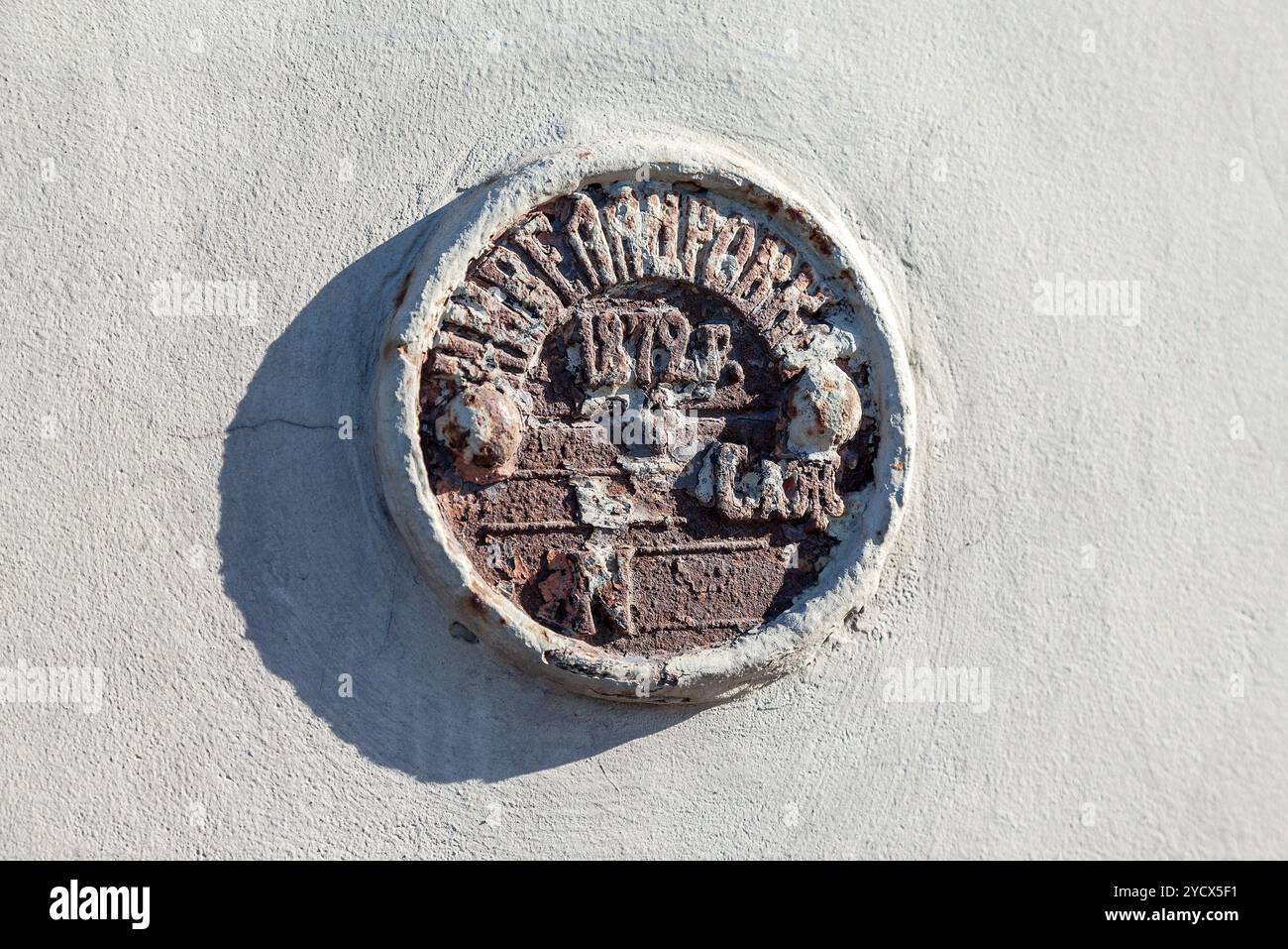 Vintage Russian government survey marker (benchmark disk) in the wall of building Stock Photo