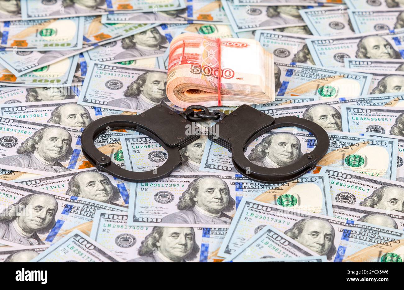Steel police handcuffs lying on the background of american dollars with ...