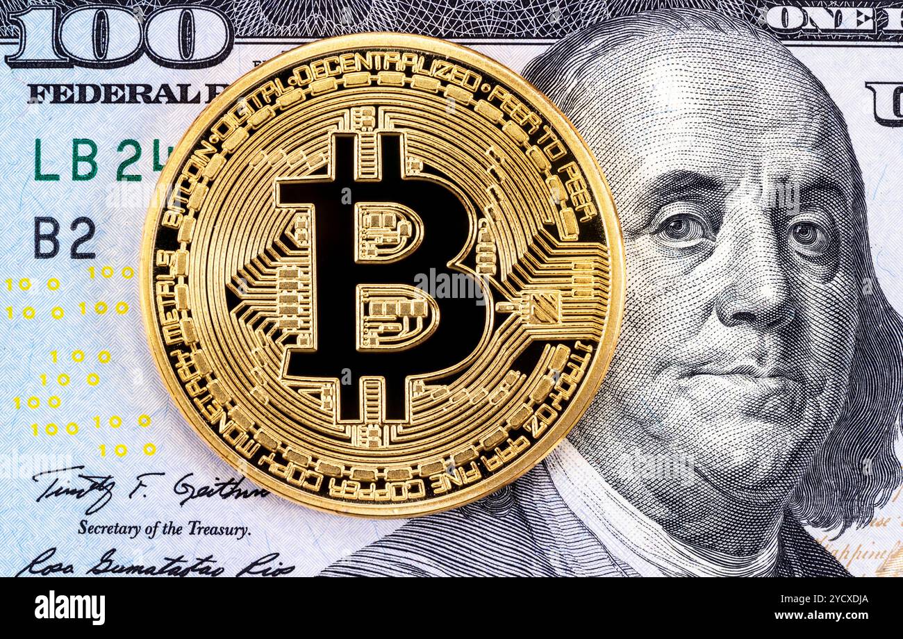 Cryptocurrency bitcoin on a one hundred dollar bill Stock Photo - Alamy