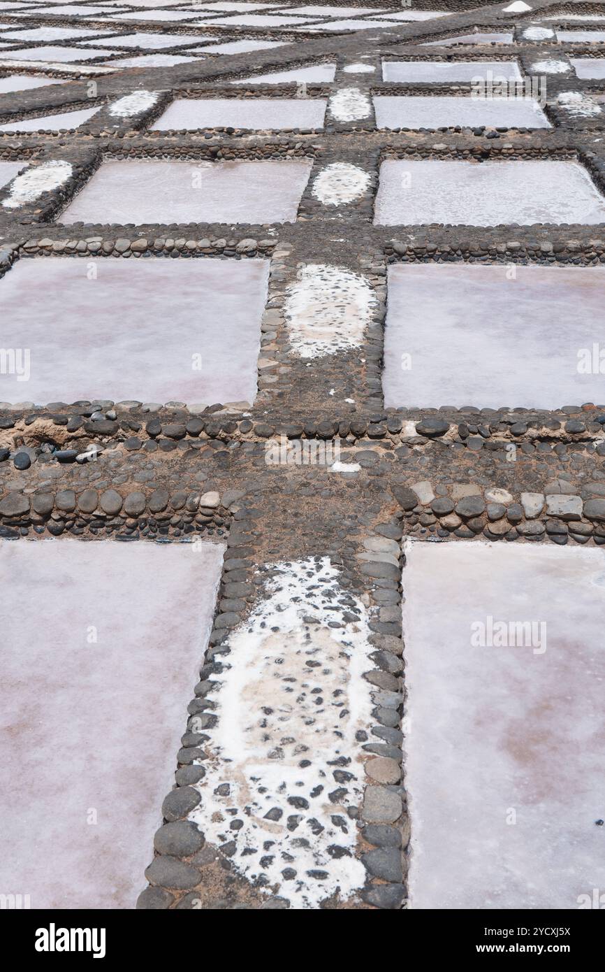 Aerial view of salt evaporation ponds artfully divided by rocky ...