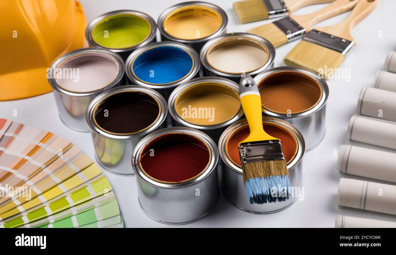 Tin cans with paint and brushes Stock Photo