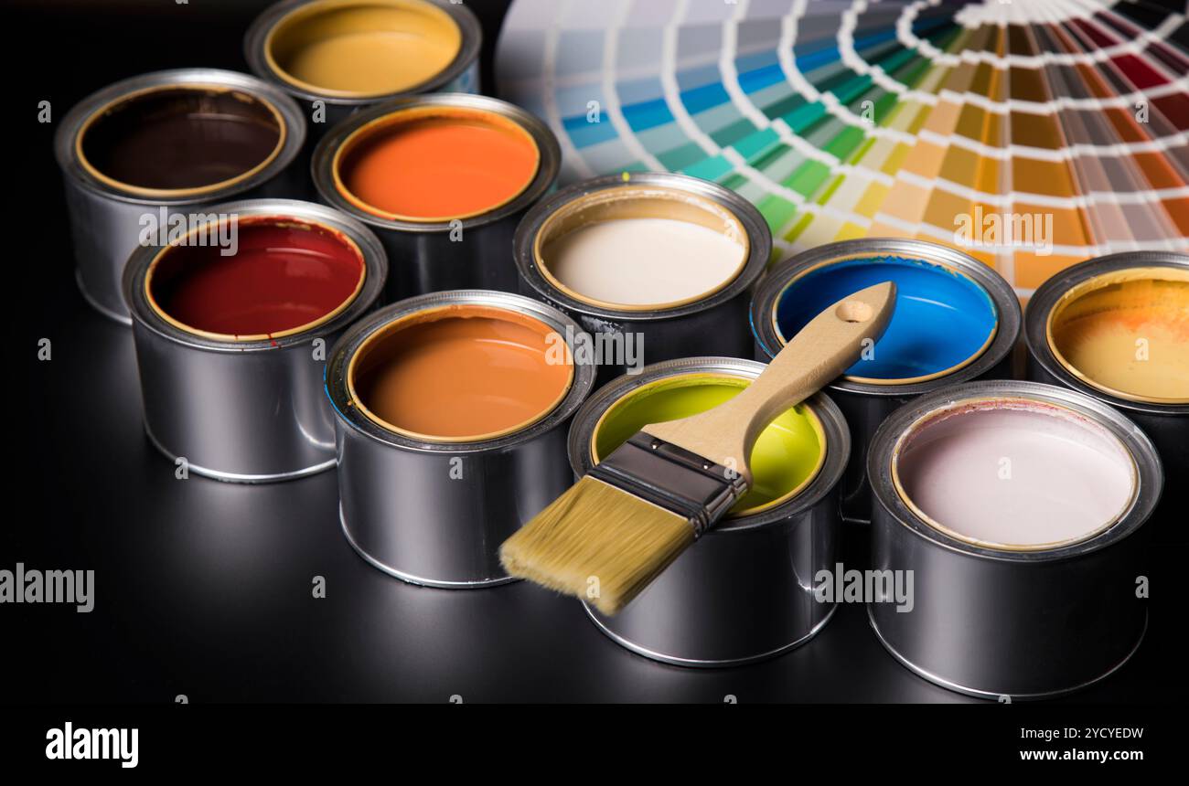 Tin cans with paint and brushes Stock Photo