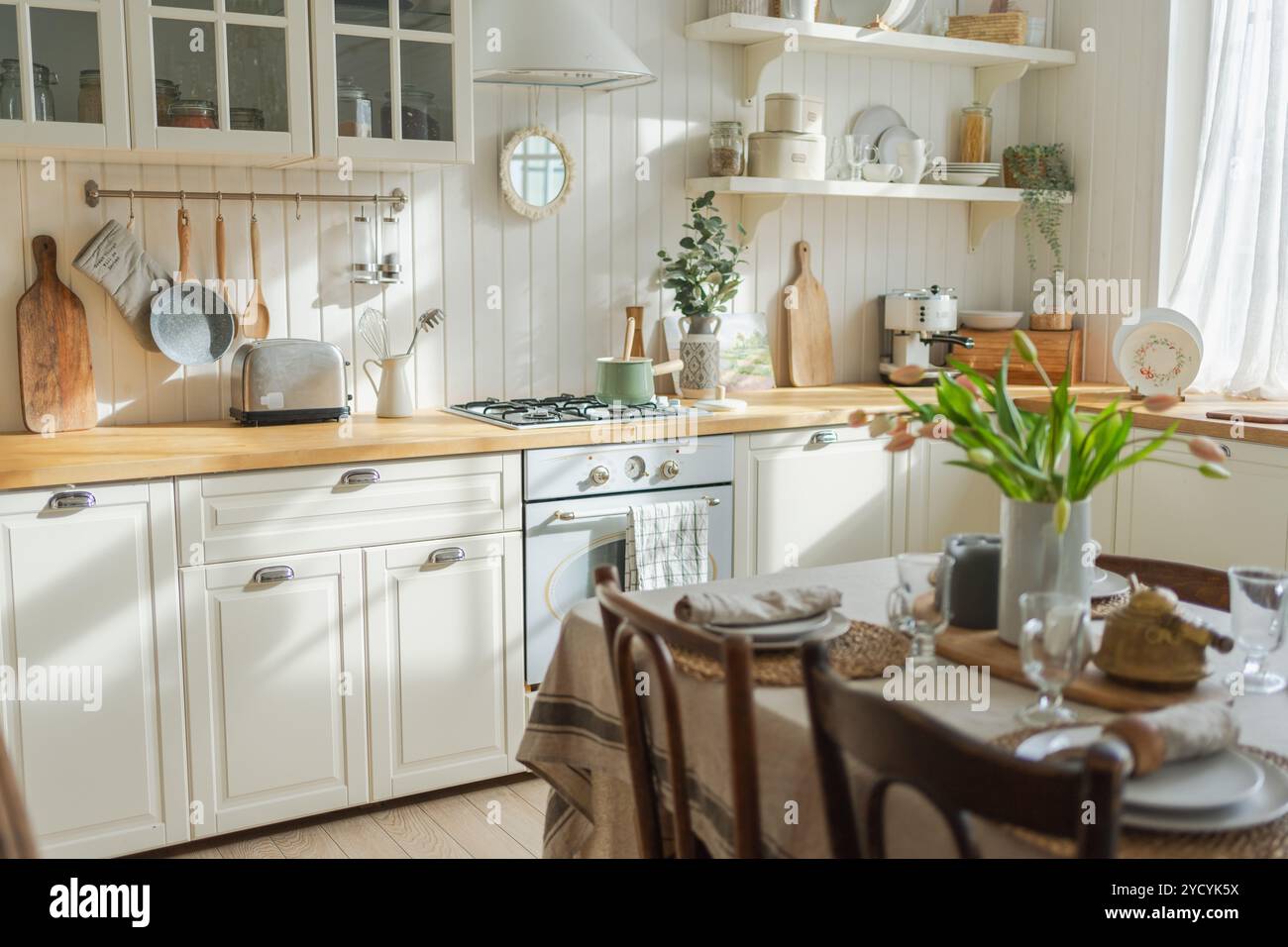 View of Scandinavian classic minimalistic kitchen with white and wooden details ...