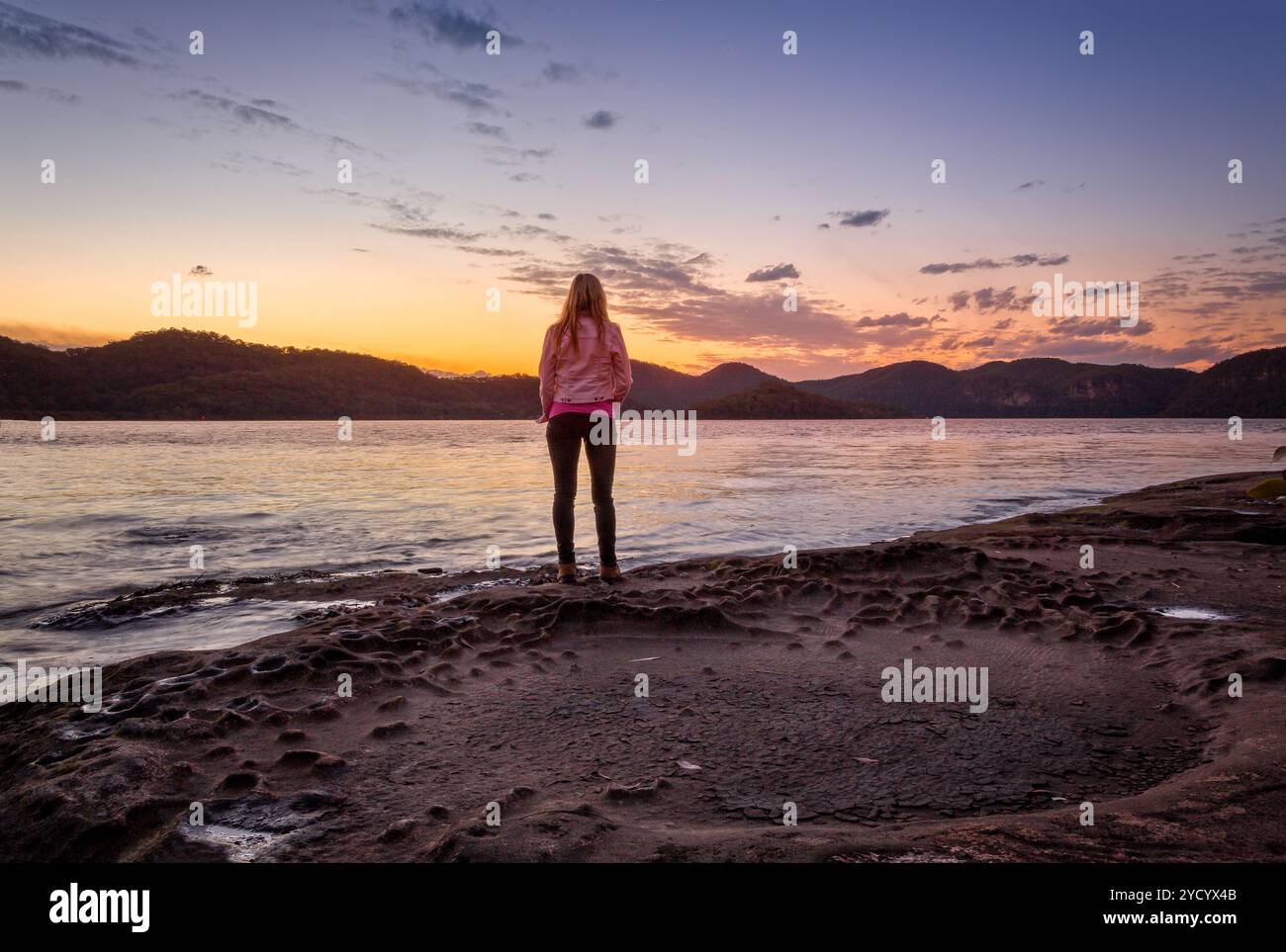Watching the sunset from foreshore of Peat Island Stock Photo