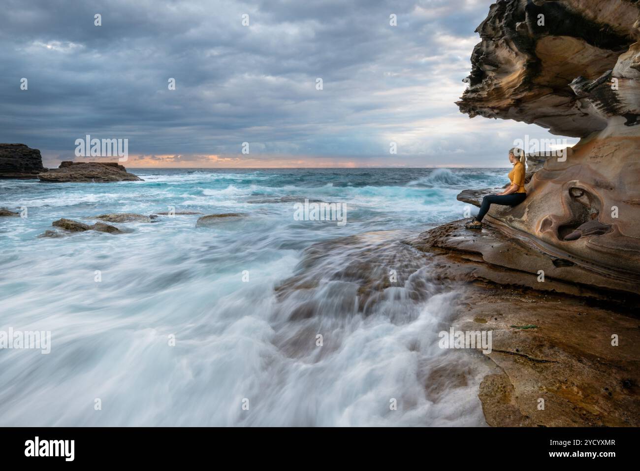 Woman on rock watching waves hi-res stock photography and images - Alamy