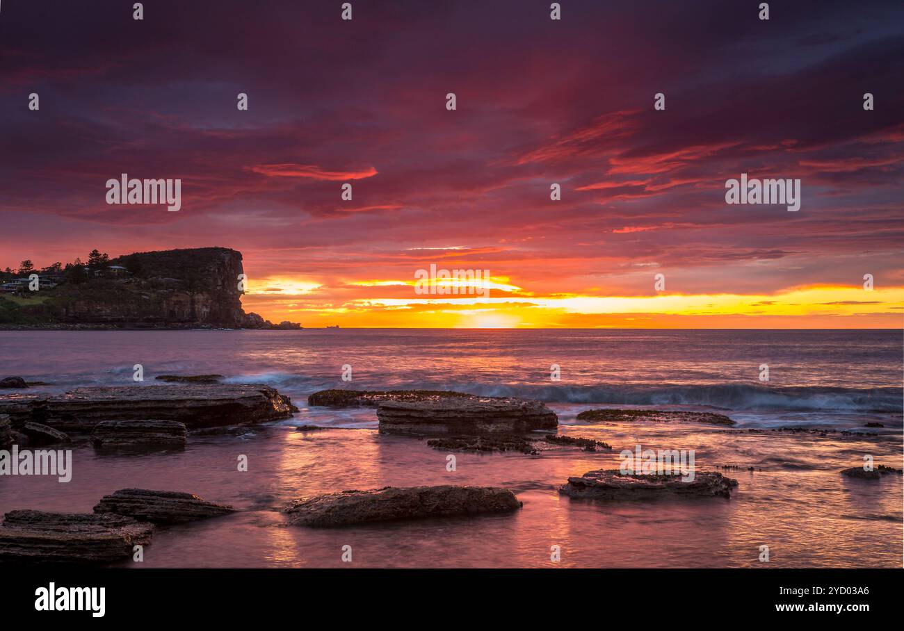 Coastal sunrise red skies Stock Photo - Alamy