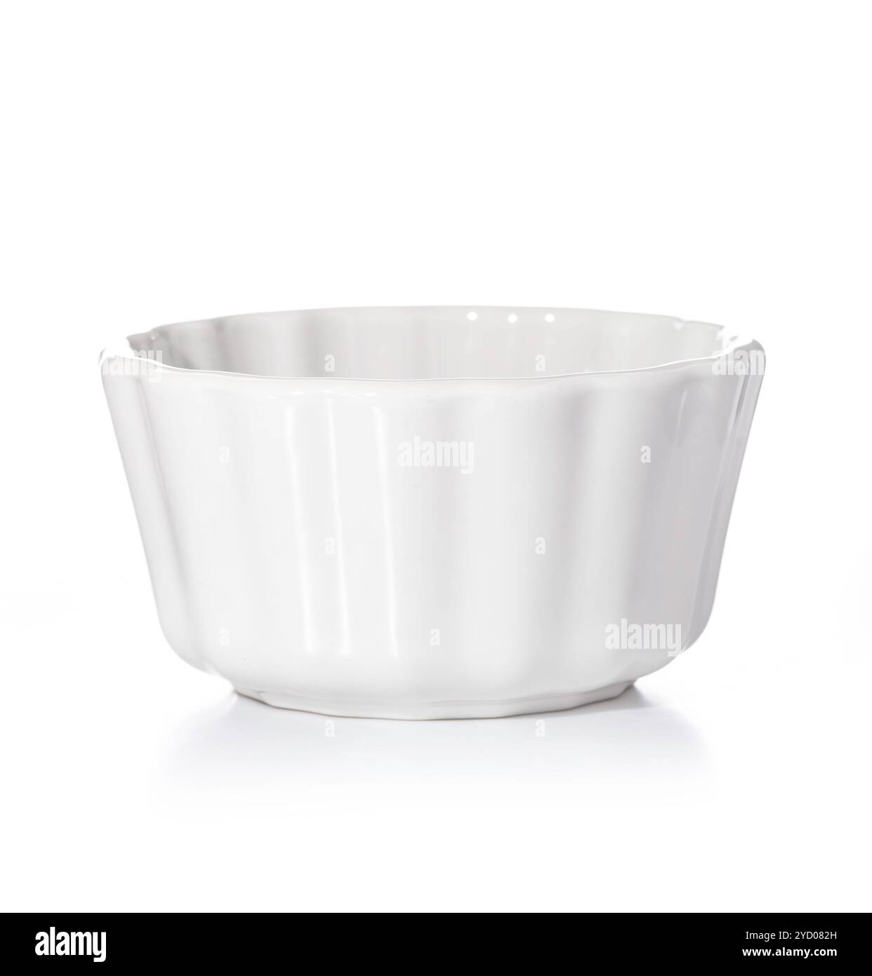 Round ceramic baking tray isolated on white background. Small glazed ceramic ramekin. Stock Photo