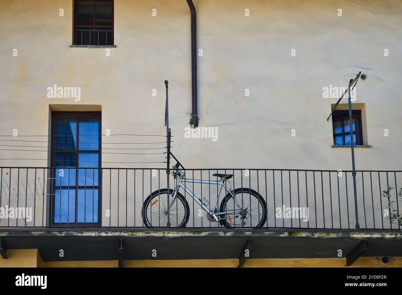 A bicycle on the balcony of an old house, Aosta, Aosta Valley, Italy Stock Photo