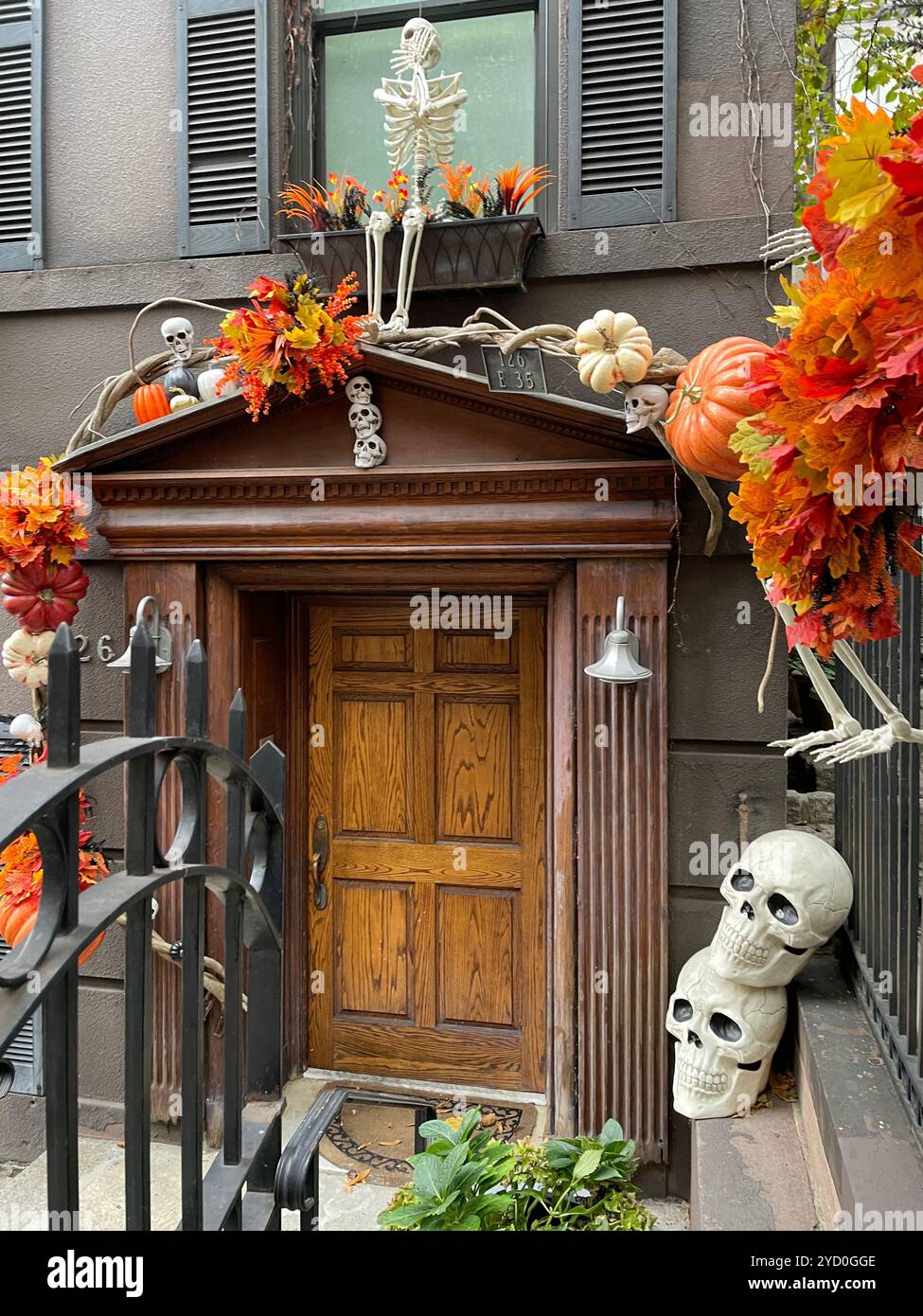 A brownstone door and entrance on E. 35th St. in Murray Hill is decorated for Halloween, 2024, New York City, USA - Smartphone Captured Stock Image