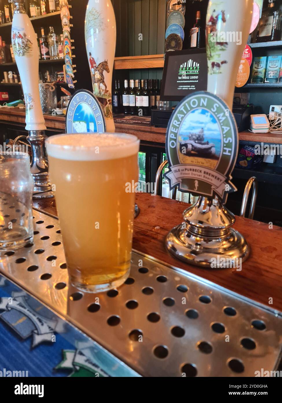 A pint of beer in a pub in Purbeck Dorset. The beer is called Operation SMASH remembering the d-day rehearsal that took place at Studland bay. - Smartphone Captured Stock Image